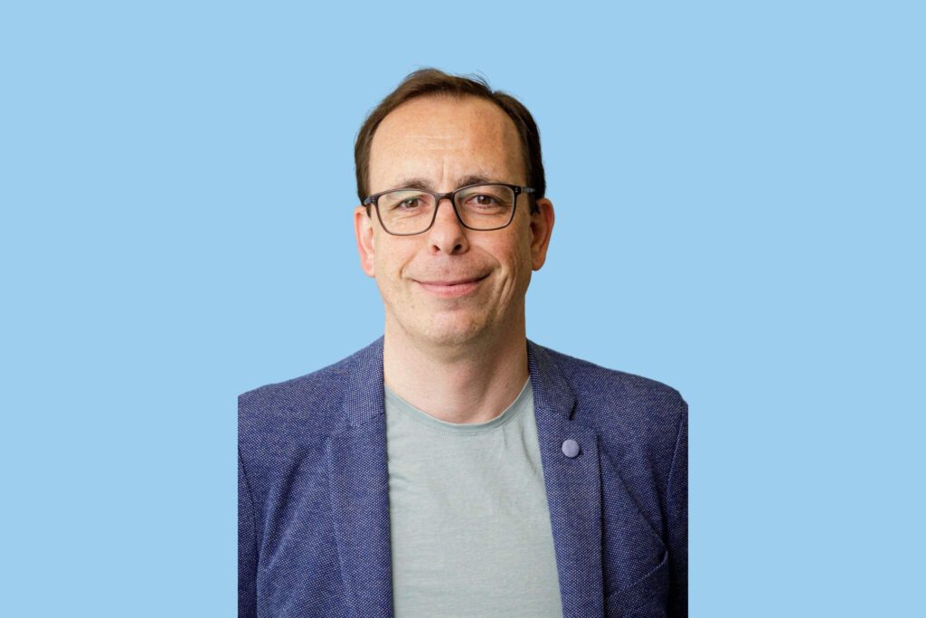 weißer Mann mit kurzen braunen Haaren, Brille
